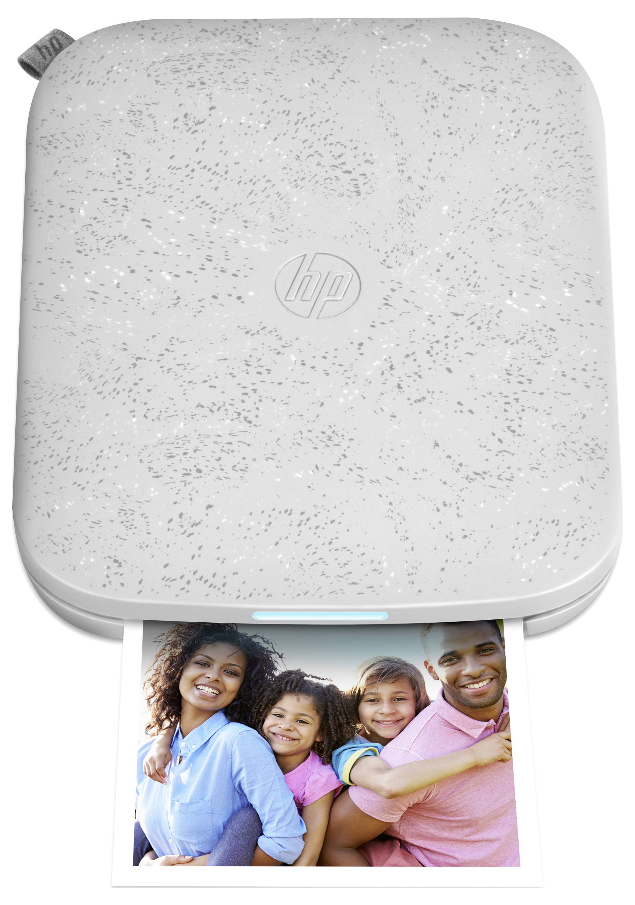 White HP portable printer with a photo of a smiling family being printed from the front slot.