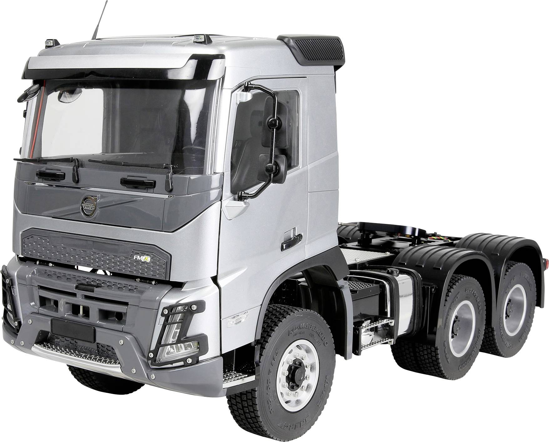 Silver three-axle semi-truck cab viewed from the front-left on a white background.