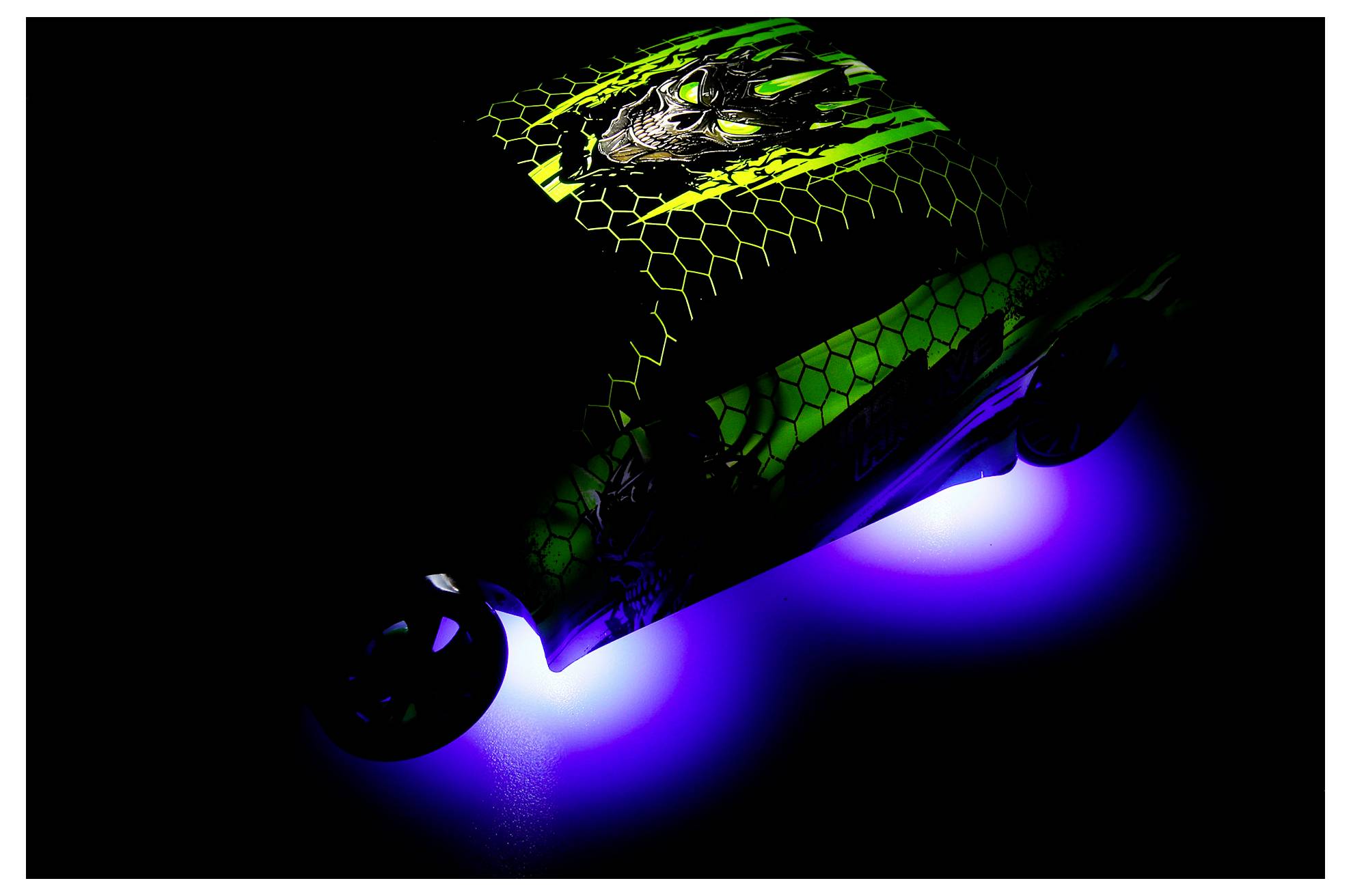 A dark electric skateboard glowing green and blue, shown at an angle against a black background.