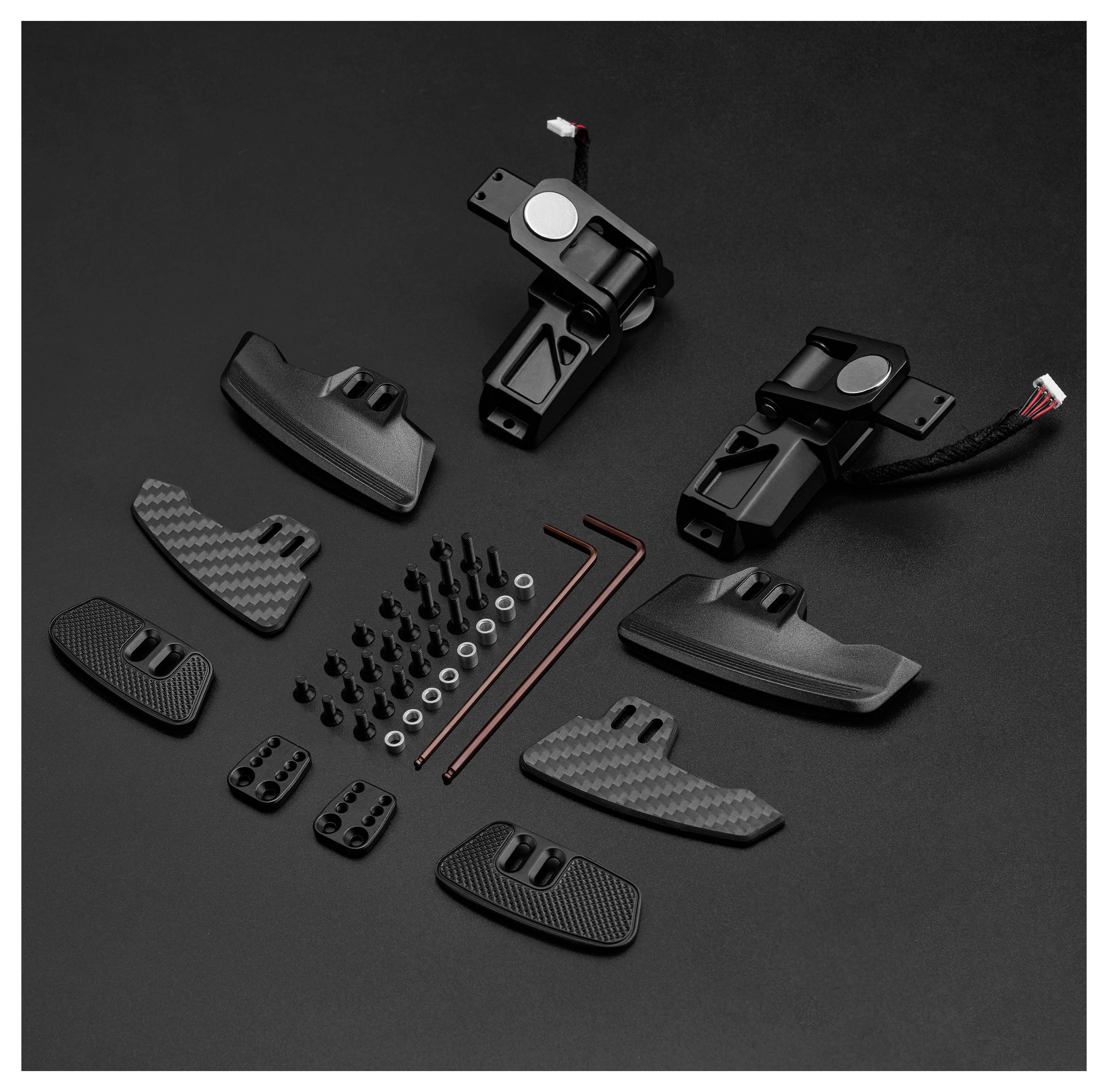Black mounting hardware kit with two bracket assemblies, several textured pads and covers, screws, washers, and hex keys arranged on a dark background.