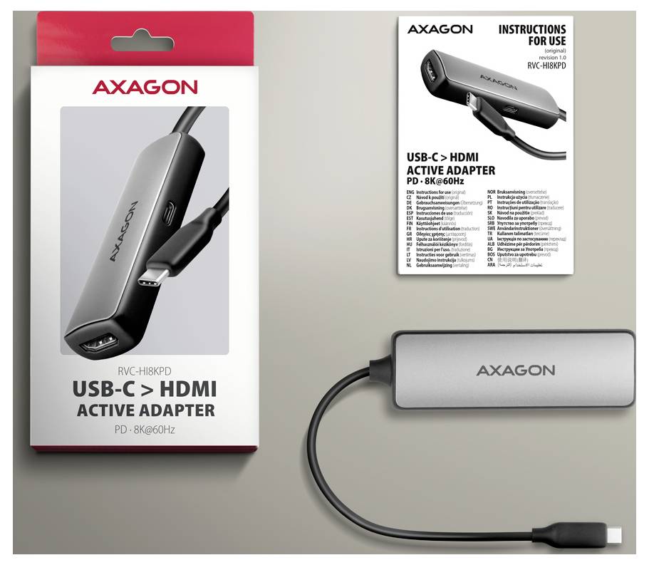 AXAGON USB-C to HDMI active adapter packaging, instruction sheet, and silver adapter shown on a beige background.