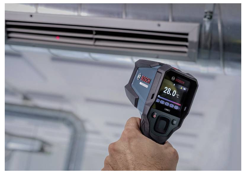 Handheld Bosch infrared thermometer measuring an air vent, showing 28.0°C on the display.
