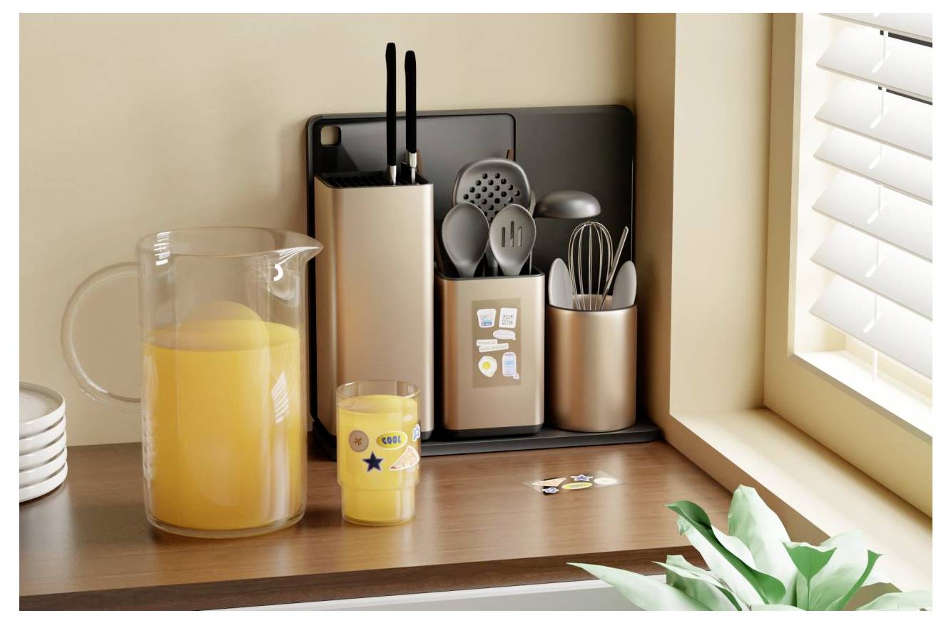 Kitchen counter with a glass pitcher of orange juice, small cup, utensil holders, and window blinds beside a sunlit corner.