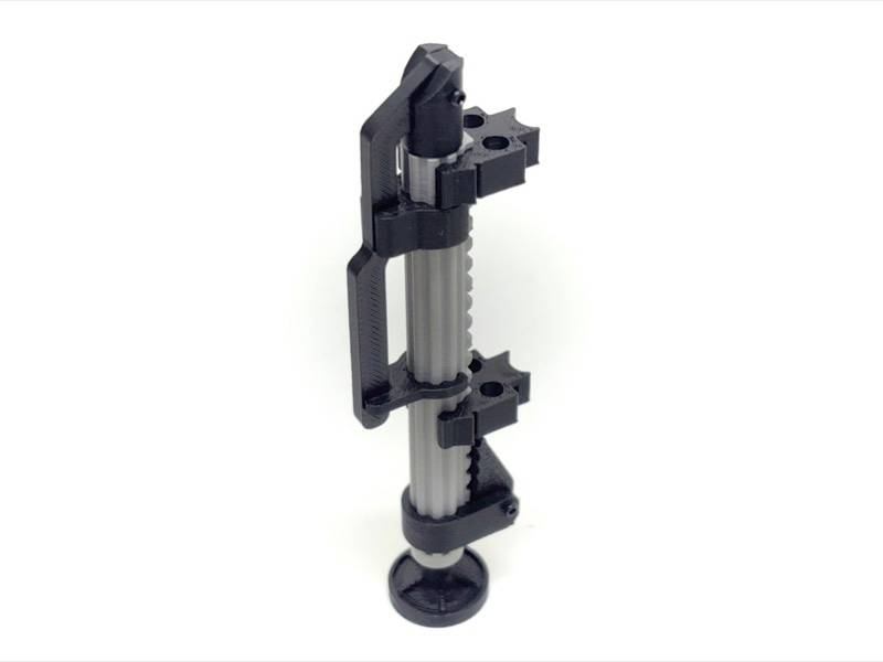 3D-printed adjustable vertical clamp with a central ridged rod and suction-cup base, shown isolated on a white background.