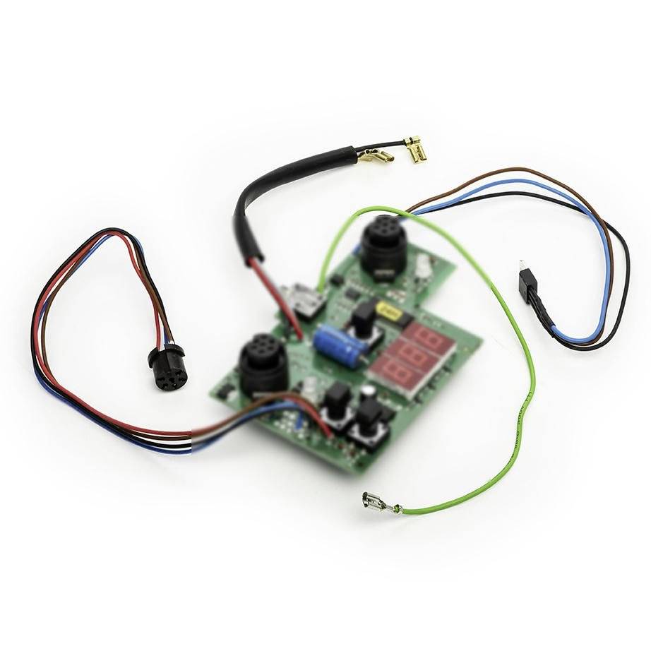 Electronic circuit board with two black components, a red LED display, and several colored wires and connectors on a white background.