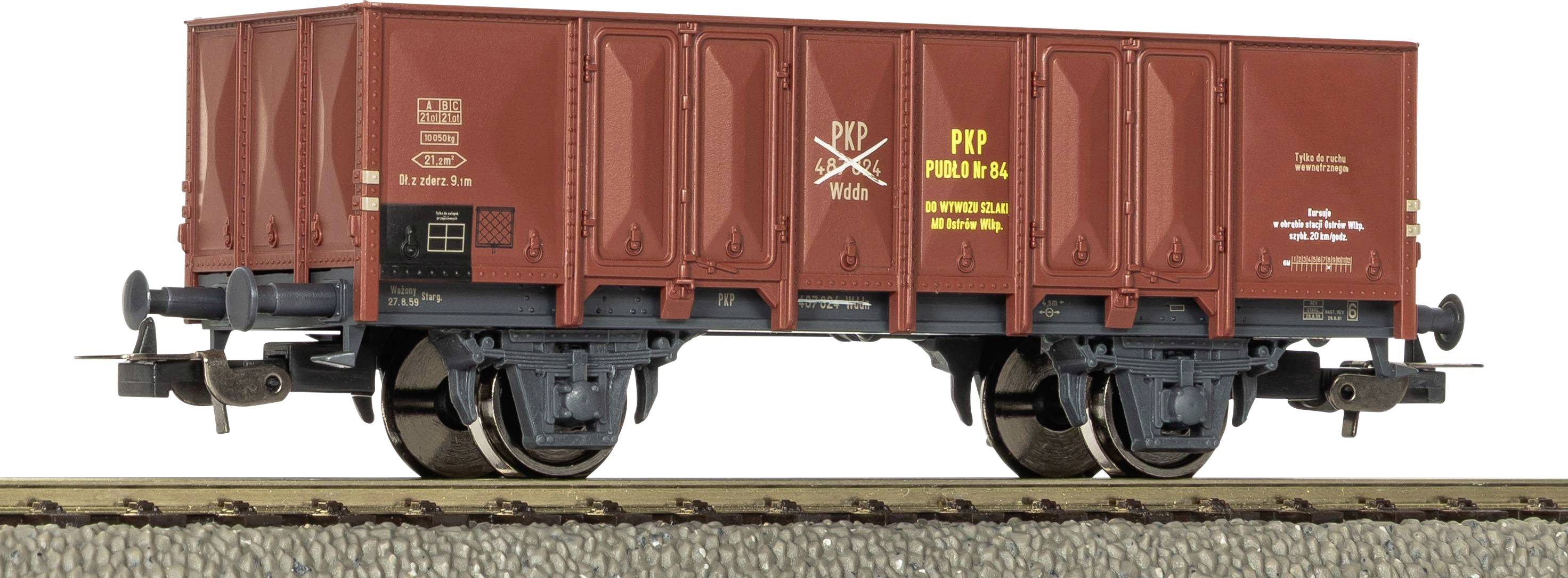 Side view of a red freight railcar on tracks, with large sliding doors and visible wheel assemblies.