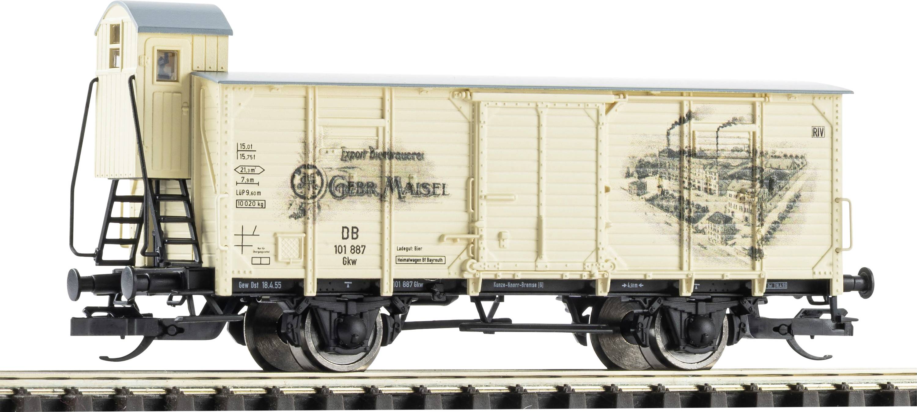 Vintage cream model boxcar on railroad track, with a small cupola end and black undercarriage, shown side view on a white background.