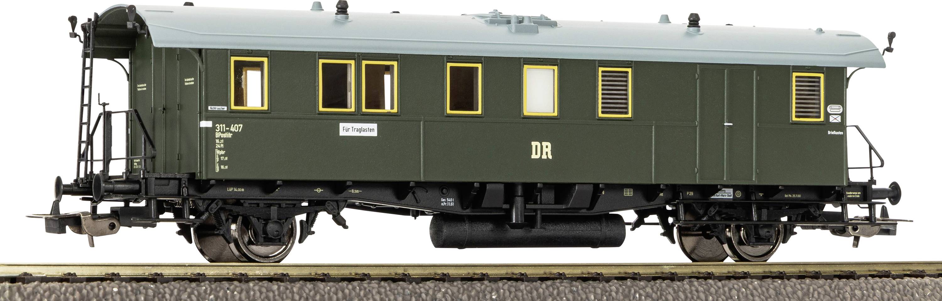 A dark green vintage railway passenger car with yellow-trimmed windows and 'DR' lettering, shown side view on tracks.
