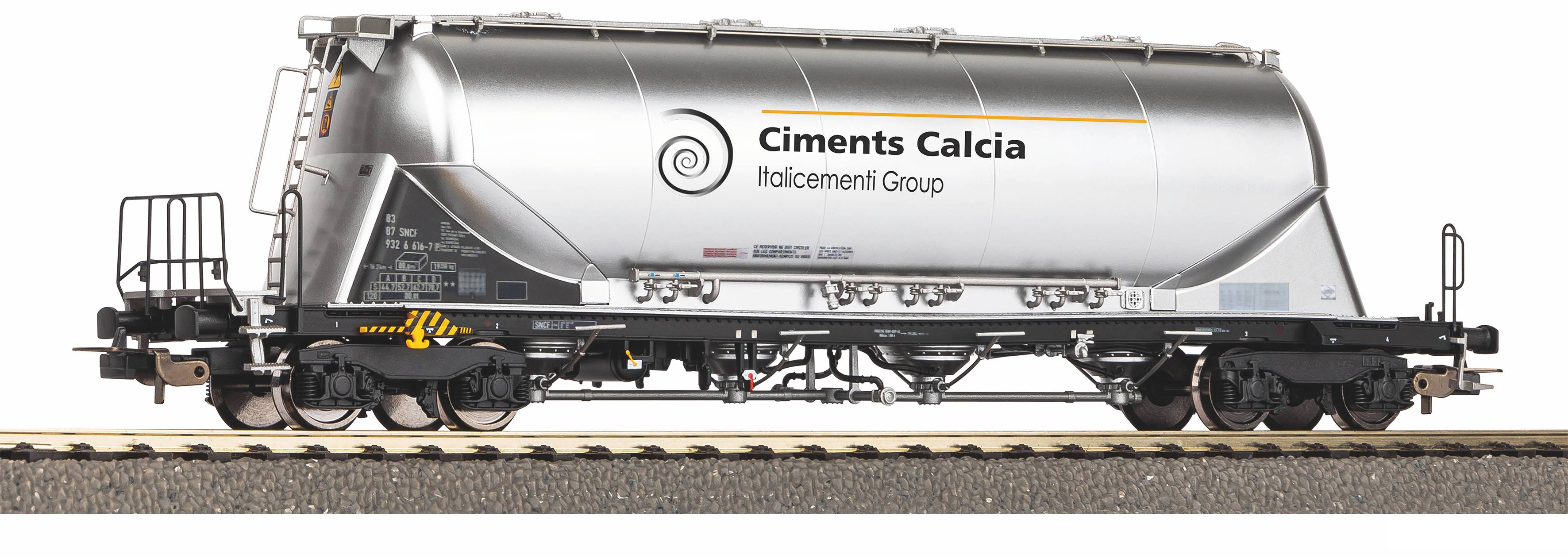 Side view of a white Ciments Calcia rail tanker wagon with company logo, shown on tracks against a plain background.