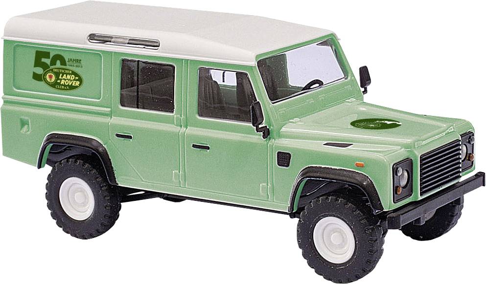Green Land Rover Defender toy model with cream roof, shown in side view on a white background.