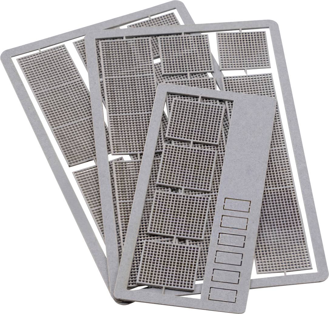 Stack of metal stencil sheets with grid cutouts and rectangular label slots, arranged overlapping on a white background.