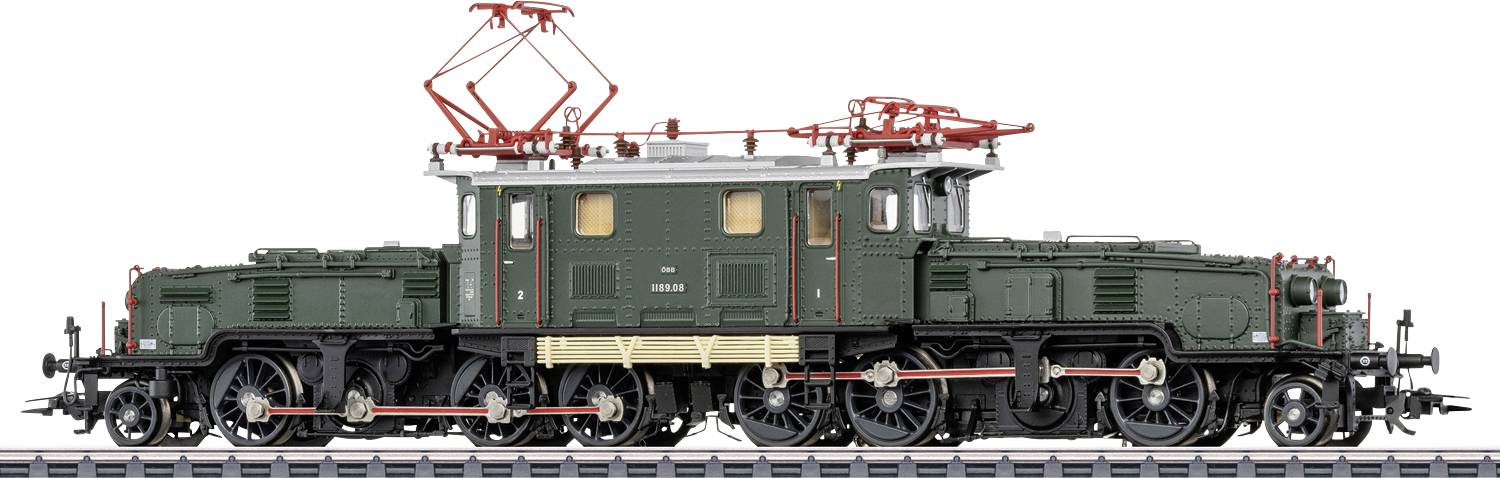 Side view of a dark green vintage electric locomotive with a red pantograph, shown on tracks against a white background.