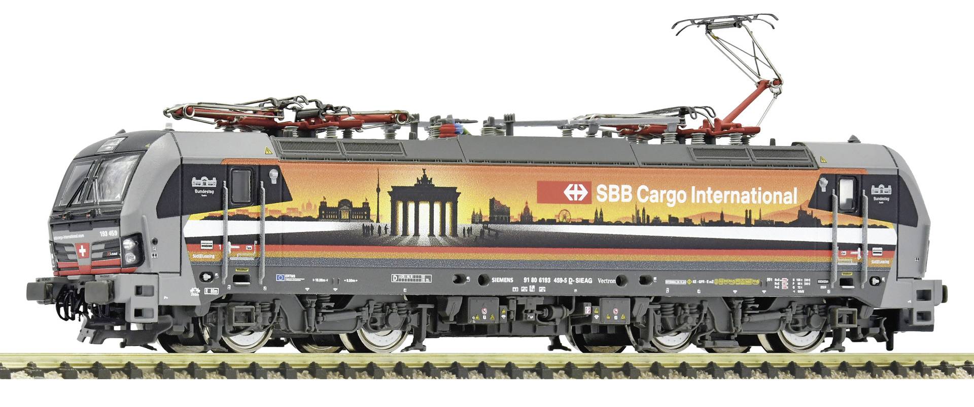 Side view of a black SBB Cargo International electric freight locomotive with orange skyline graphics and raised pantograph.
