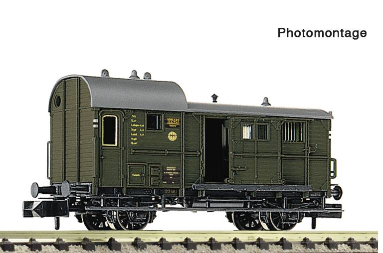 Photomontage of an old dark green railway boxcar or caboose on tracks, shown in side view against a white background.