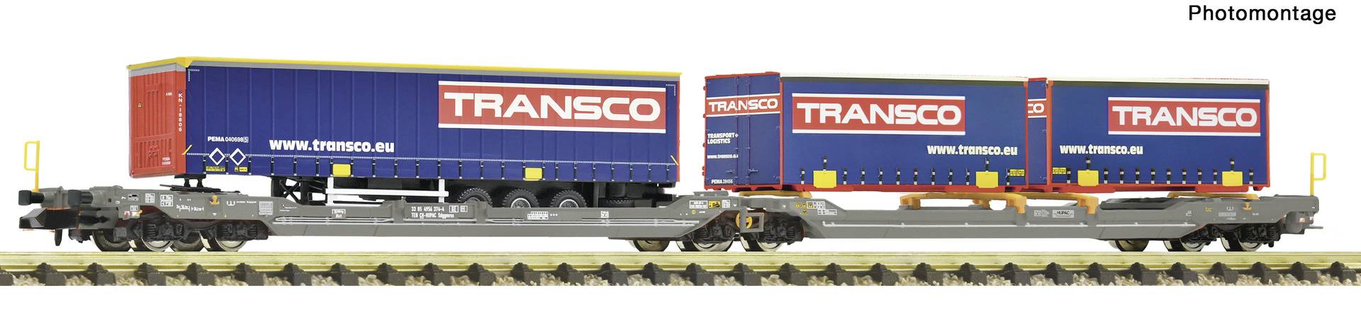 A Transco freight train with three blue and red cargo containers on flatbed wagons, shown in side view on railway tracks.