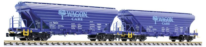 Two blue Wilson Care rail hopper cars on tracks, shown in side view with yellow detailing and white logo text.