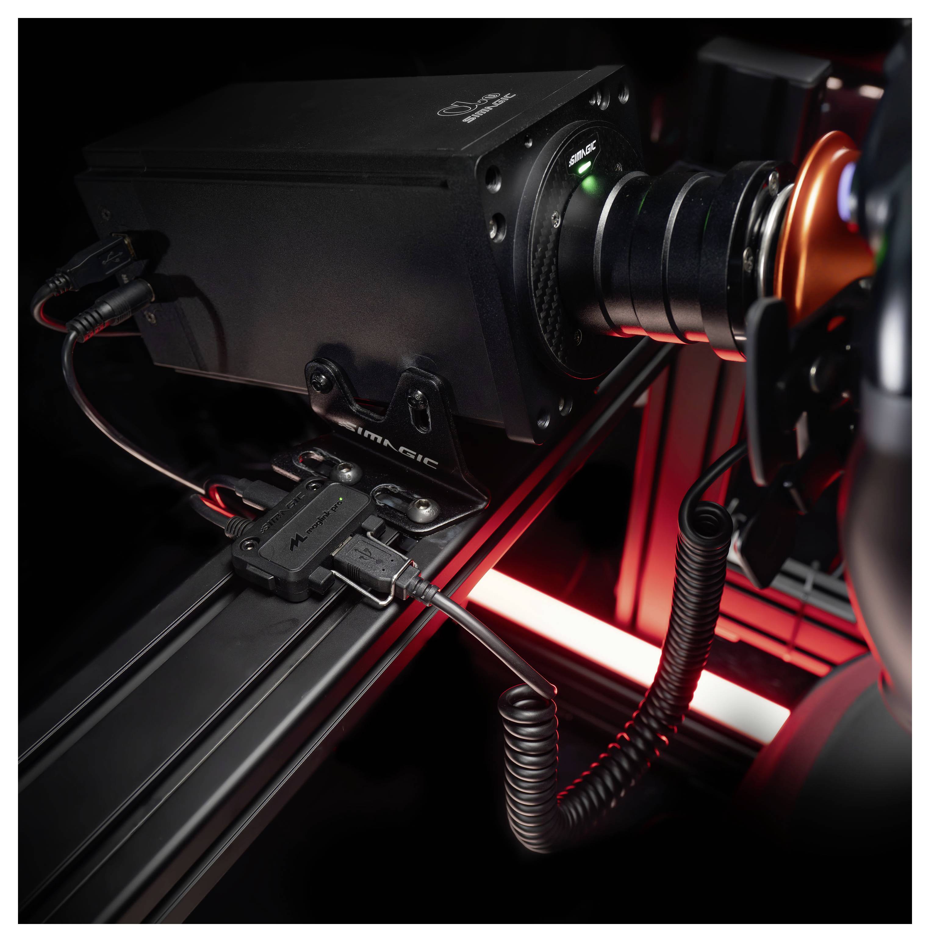 Close-up of a mounted camera rig on a rail system, with cables and a glowing red light inside a dark enclosure.
