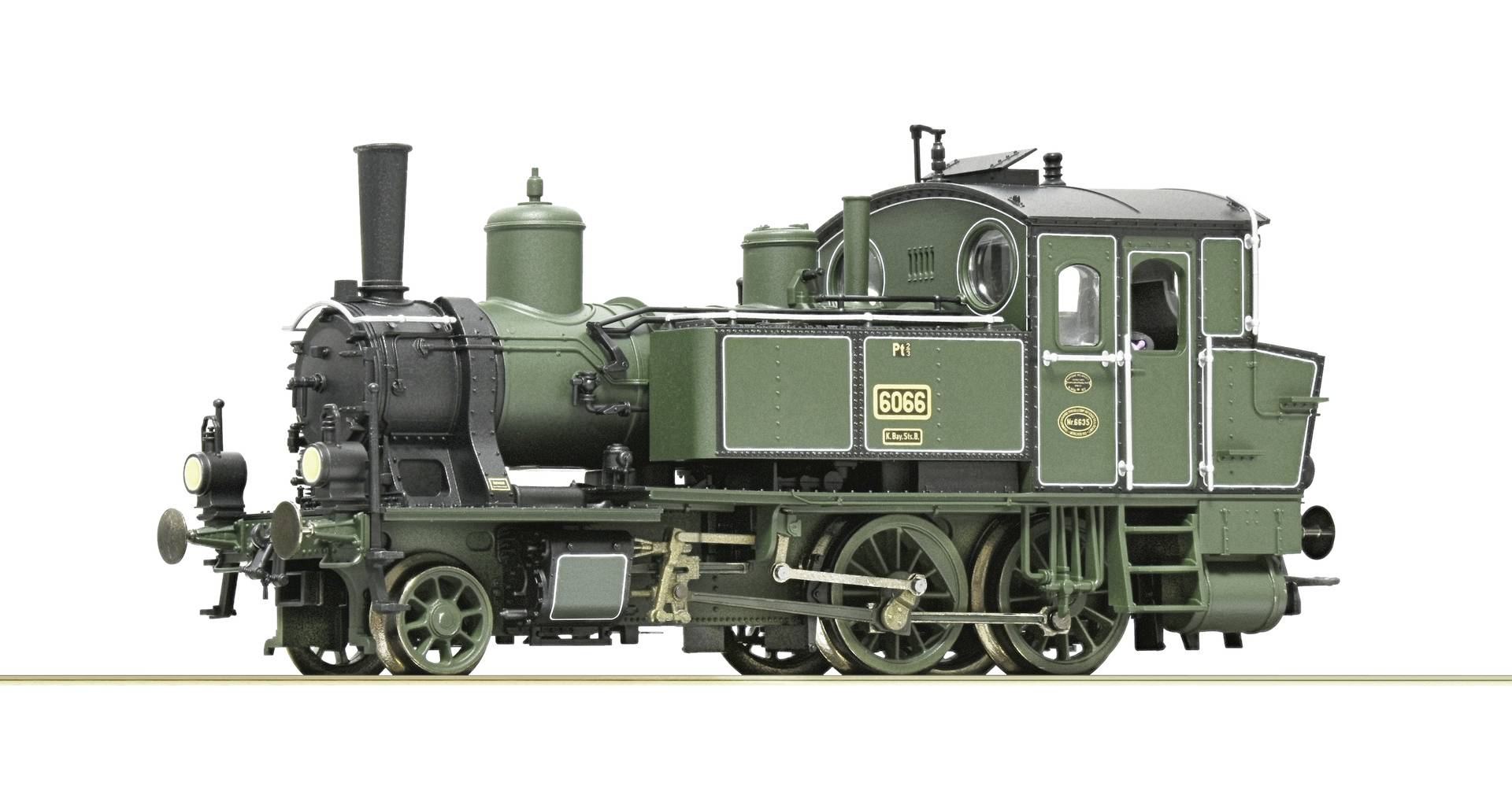 Side view of a green vintage steam locomotive isolated on a white background.