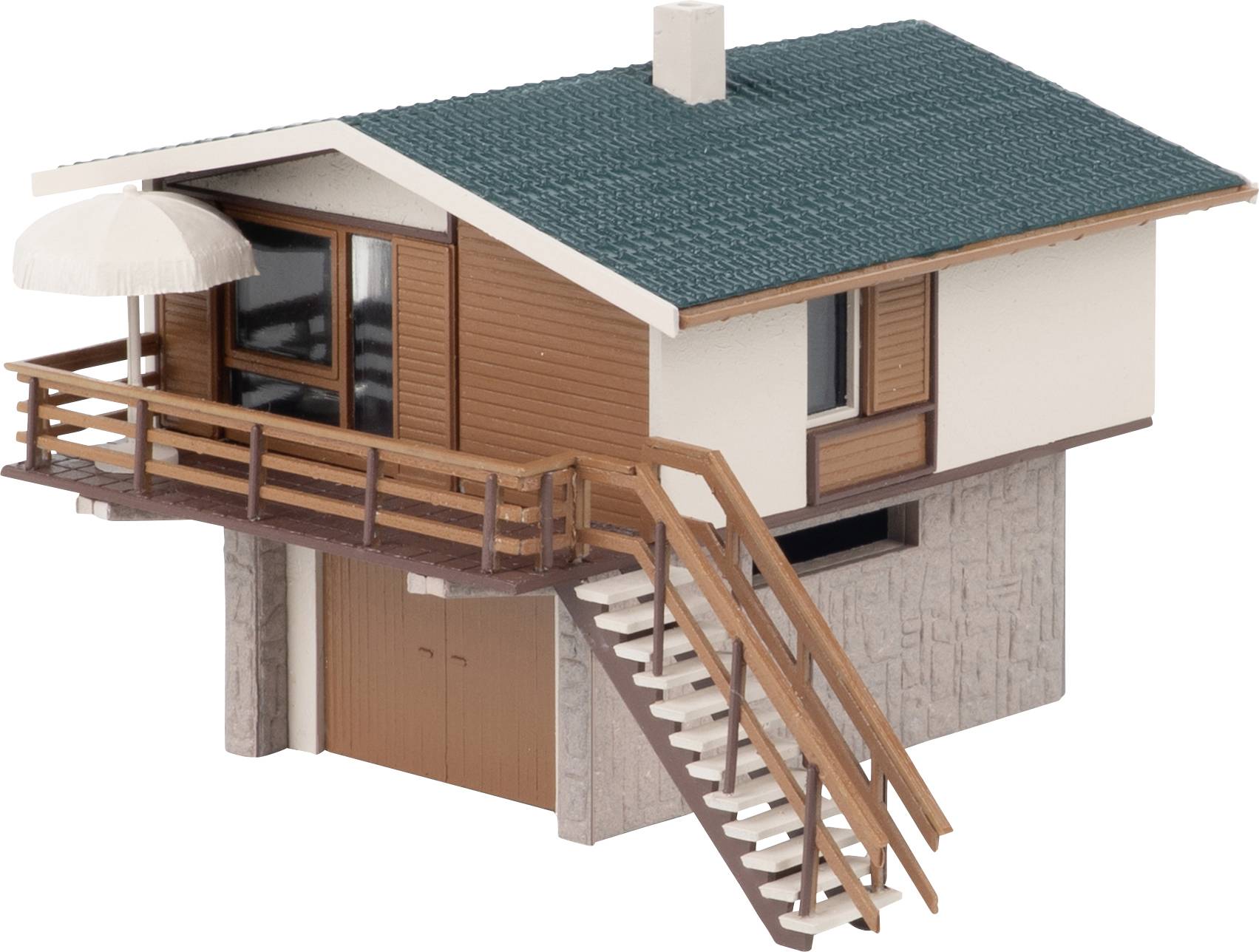 Small model of a house with green roof, wooden balcony, exterior staircase, and attached awning on a white background.