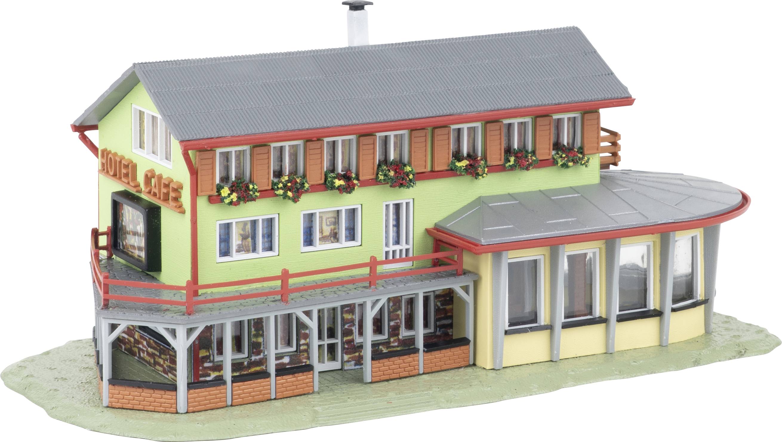 Model of a two-story hotel building with green walls, red trim, flower boxes, and a curved glass-front extension.