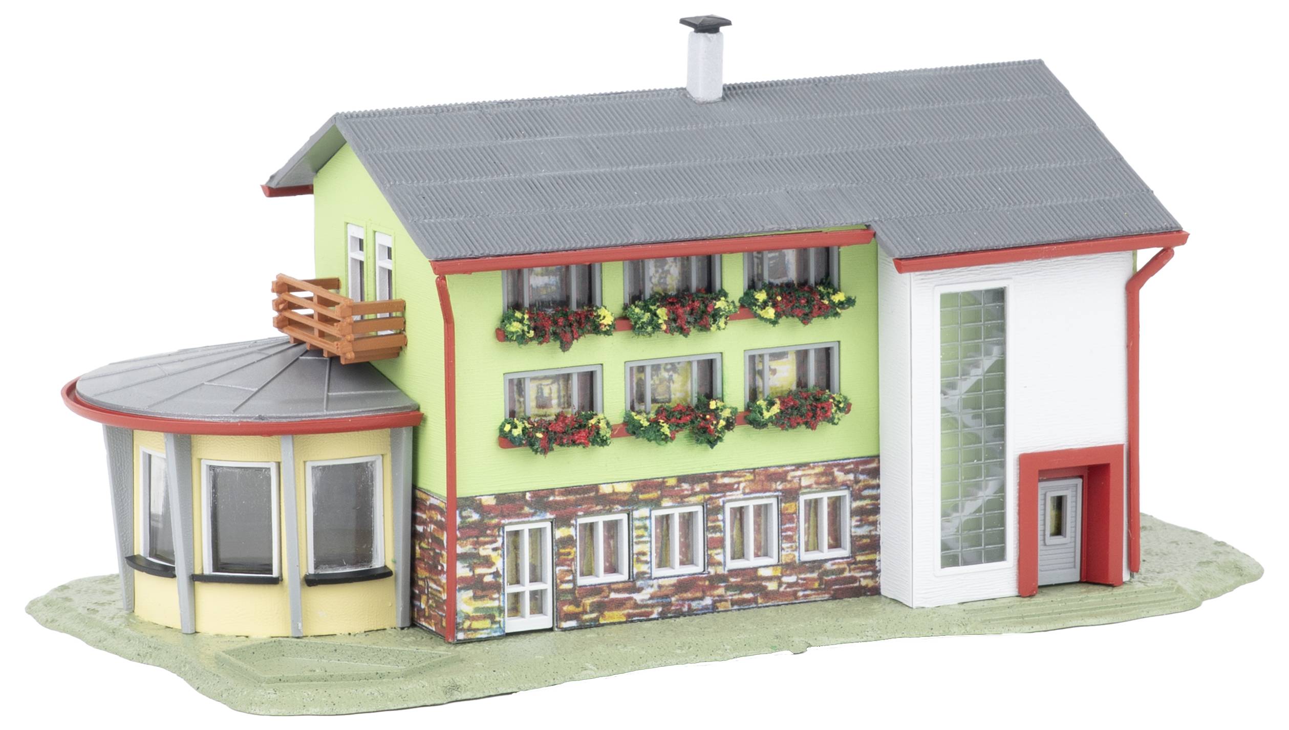 Scale model of a house with green and white walls, gray roof, rounded side porch, and flower boxes on a white background.