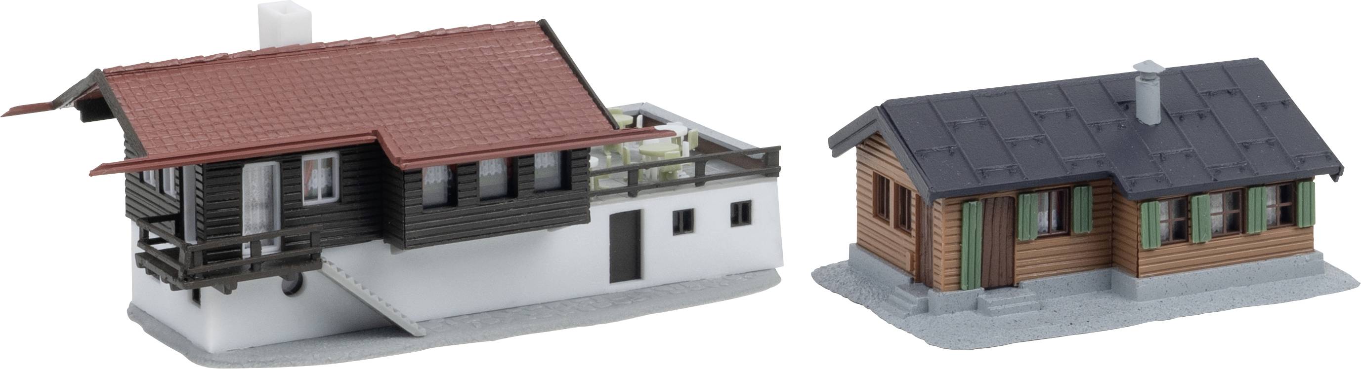 Two small model buildings: a larger red-roofed house with a white base and balcony on the left, and a smaller dark-roofed wooden cabin on the right.