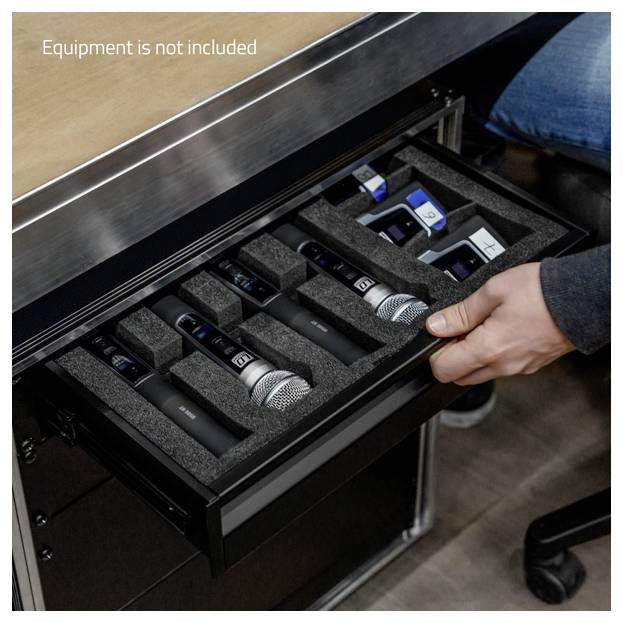 Hand opening a foam-lined drawer containing several wireless microphones and small audio devices; text says 'Equipment is not included'.