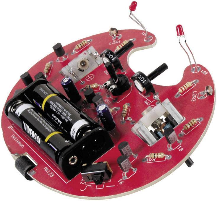 Electronic kit with a red circular circuit board, several resistors, a battery compartment with two batteries, and LEDs.