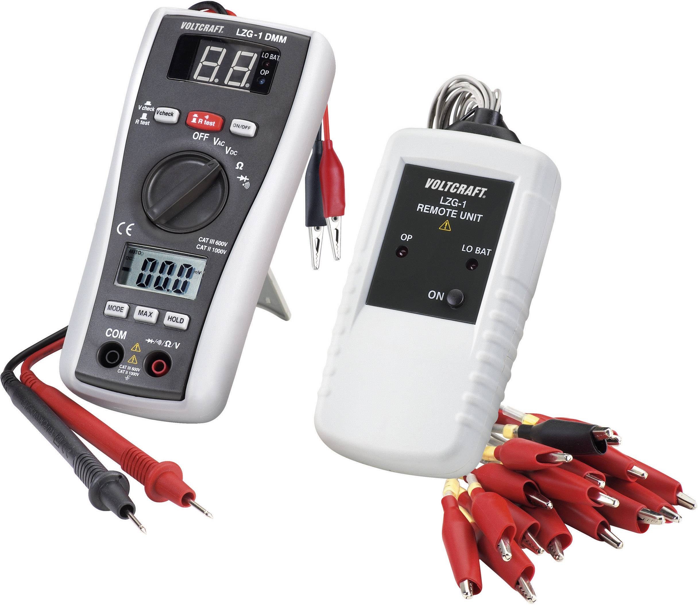 Multimeter with display and cables on the left; a remote control unit with a switch and multiple crocodile clips on the right.