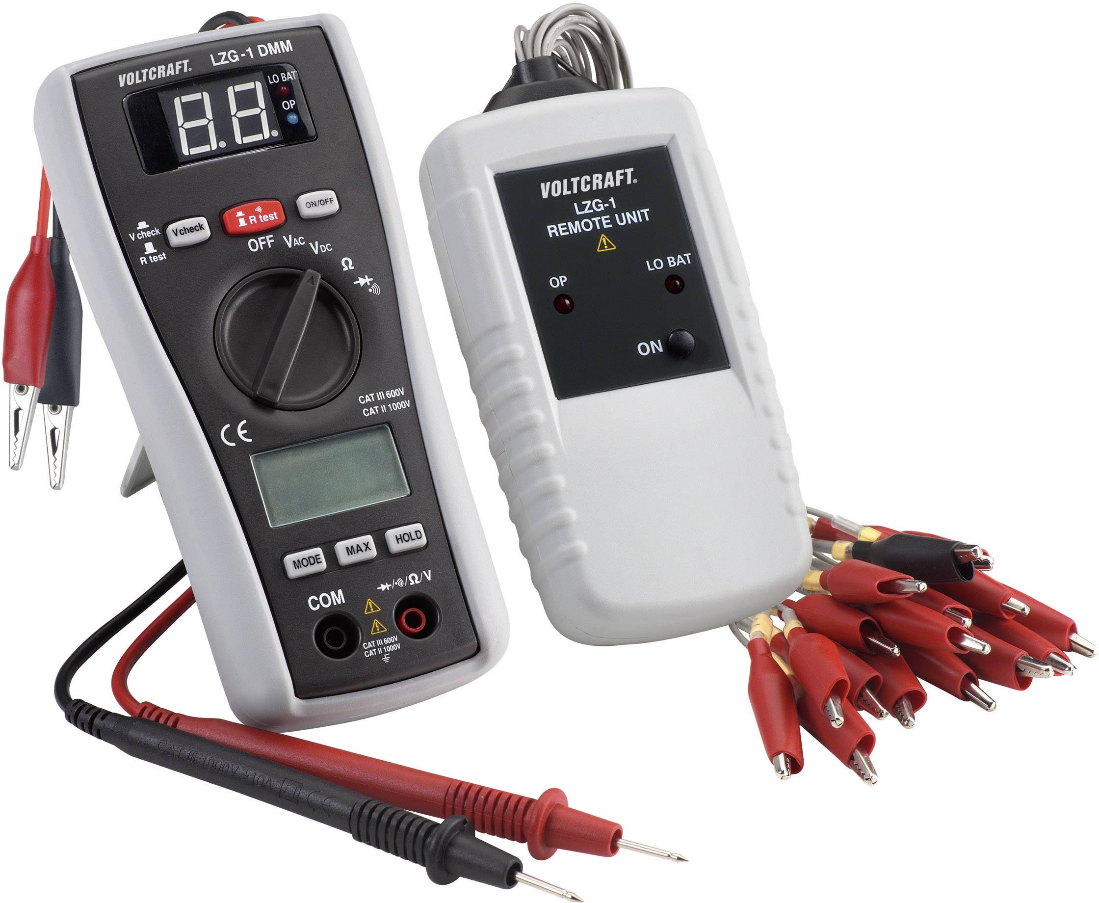 A multimeter and a remote control unit with multiple crocodile clips. Devices for electrical measurement and diagnosis.