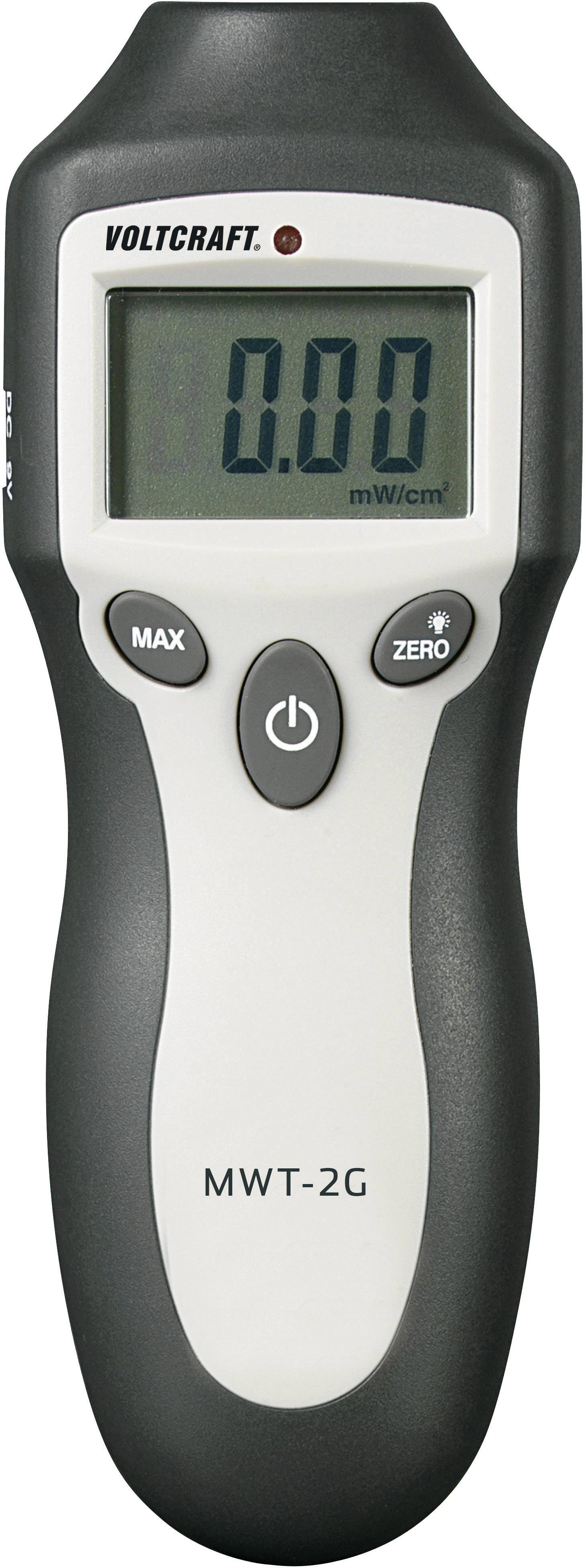 A handheld device for measuring microwave radiation displays '0.00 mW/cm²' on the screen. The brand name 'Voltcraft' and model 'MWT-2G' are visible.