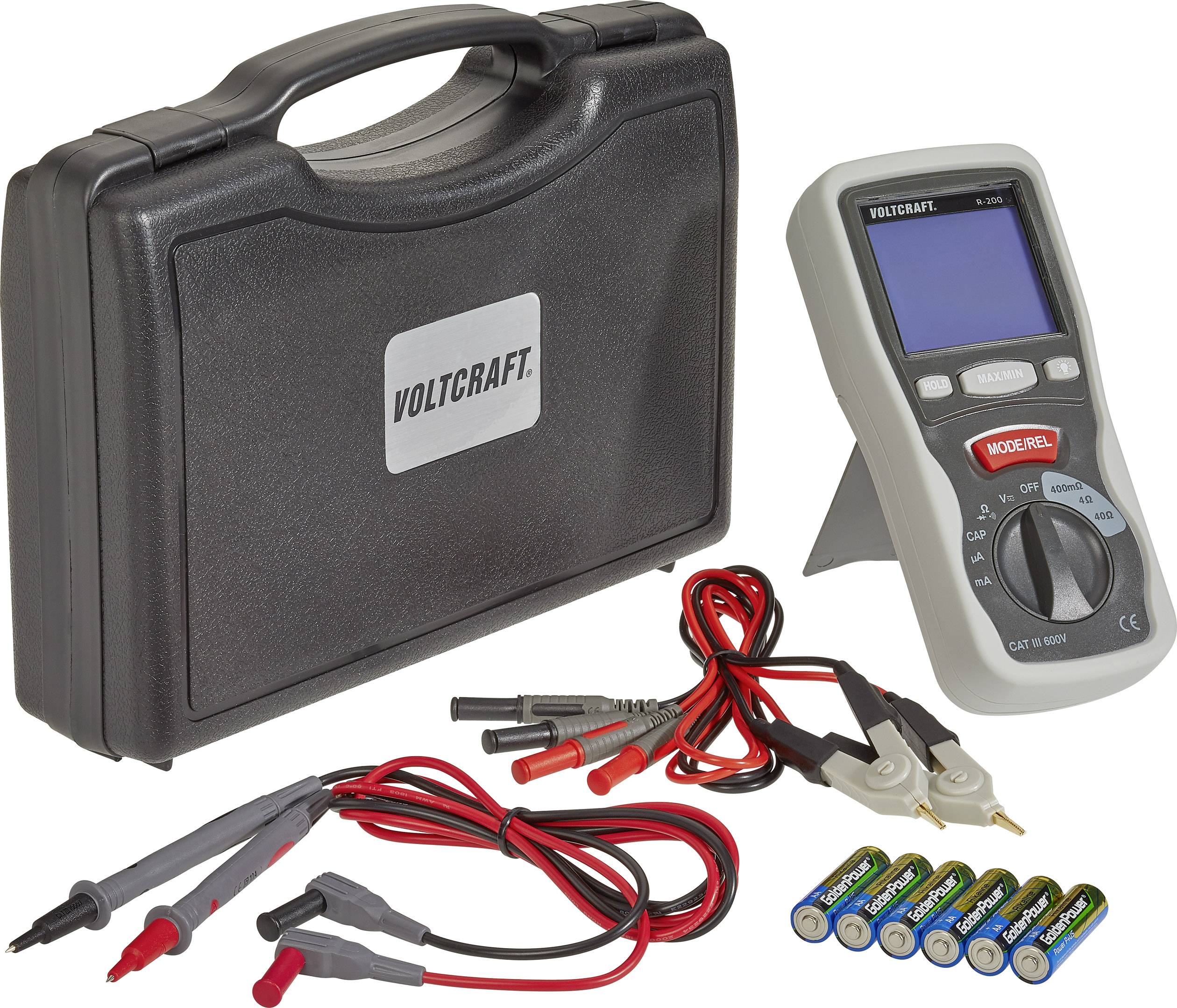 Portable multimeter set with carry case, test leads, crocodile clips, and batteries. Device displays electrical measurement values.