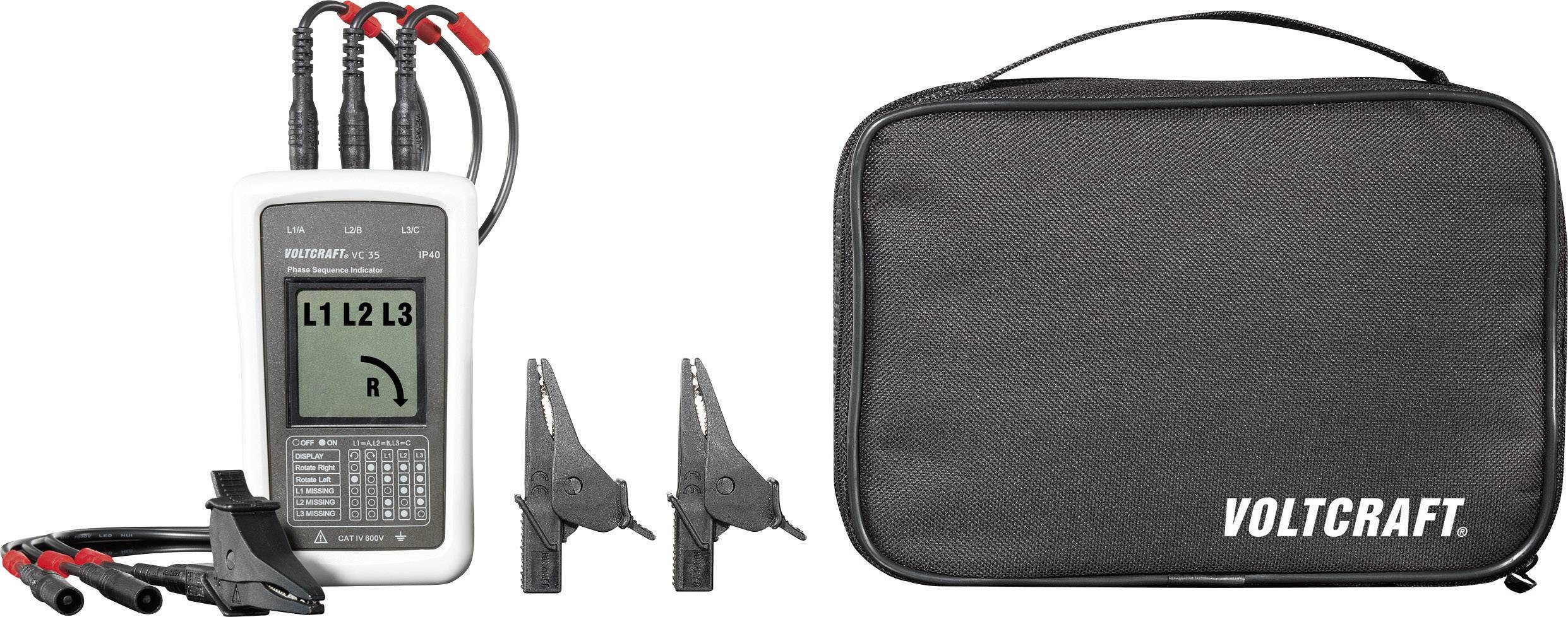 A phase testing device with display shows the phases L1, L2, L3. Next to it are terminals and a black bag with 'VOLTCRAFT' logo.