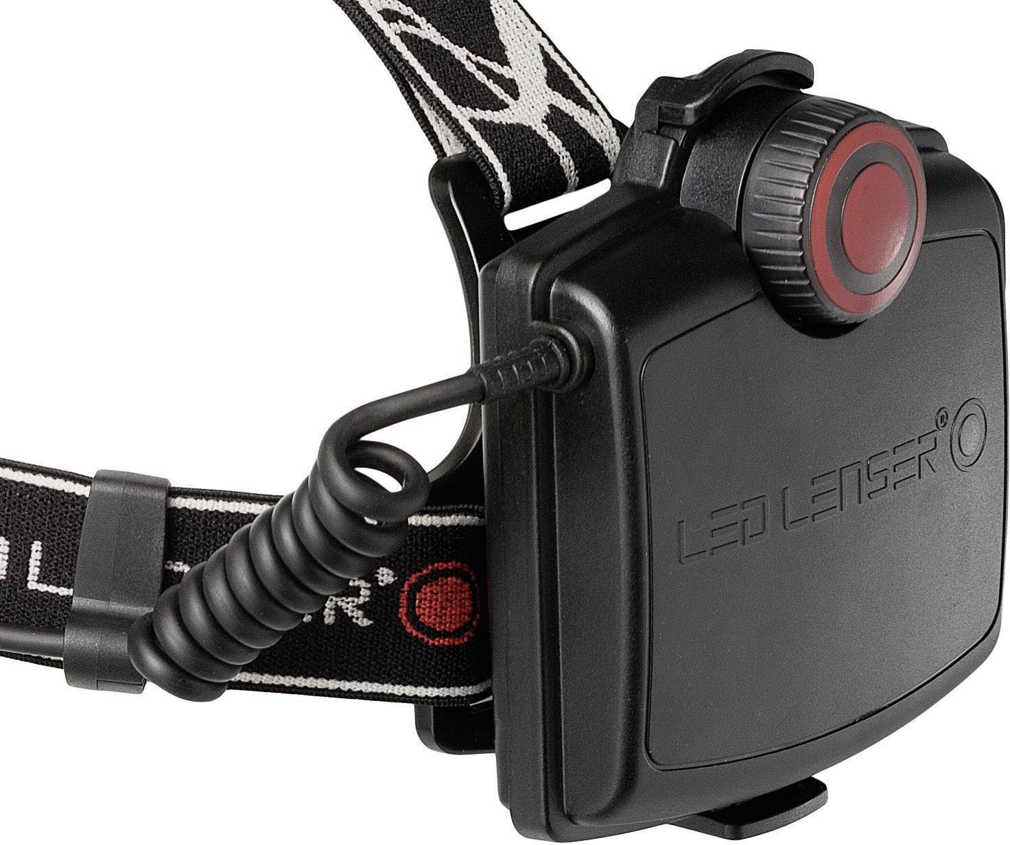 Black LED Lenser battery compartment with red button, attached to a black headband with white pattern and cable connection.