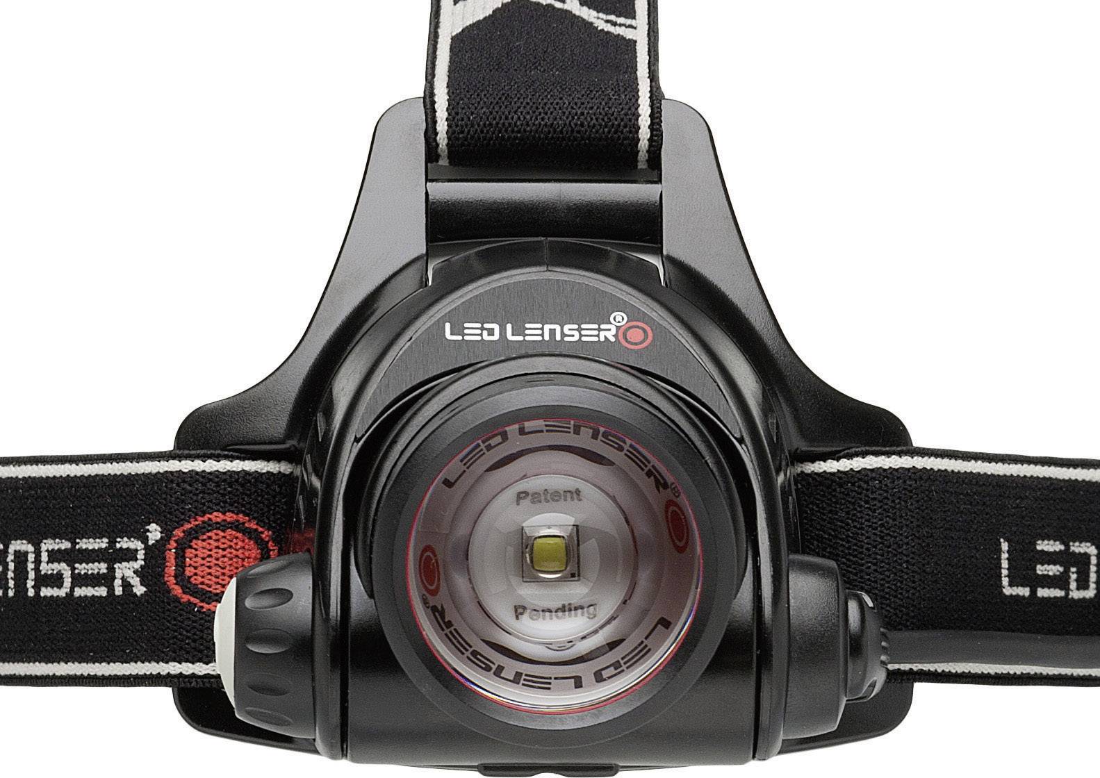 Head torch with a black casing and 'LED Lenser' logo, with a central light source and adjustable headband, positioned on a white surface.