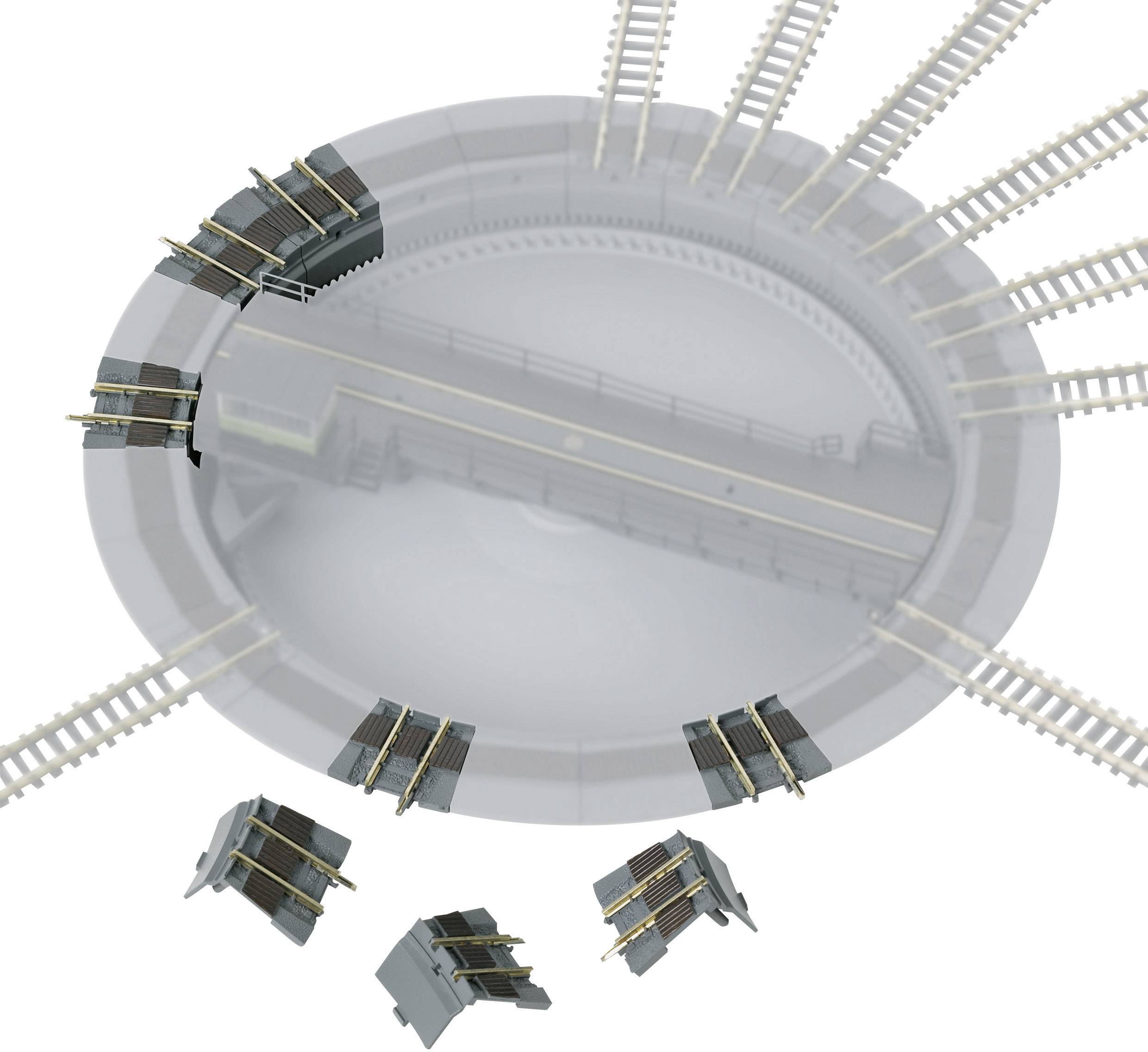 A model railway turntable with multiple track connections and two locomotives positioned, symbolising point switching.