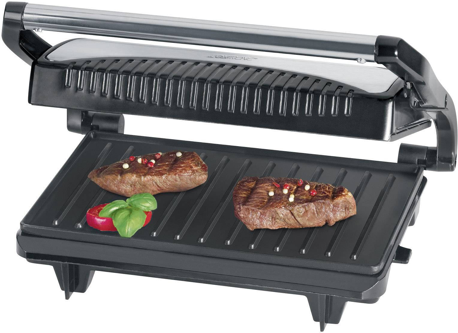A contact grill with two grilled steaks, seasoned with peppercorns, alongside a red pepper and a basil leaf.