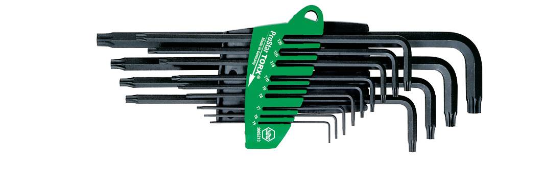 A set of black allen keys in various sizes, organised on a green holder.