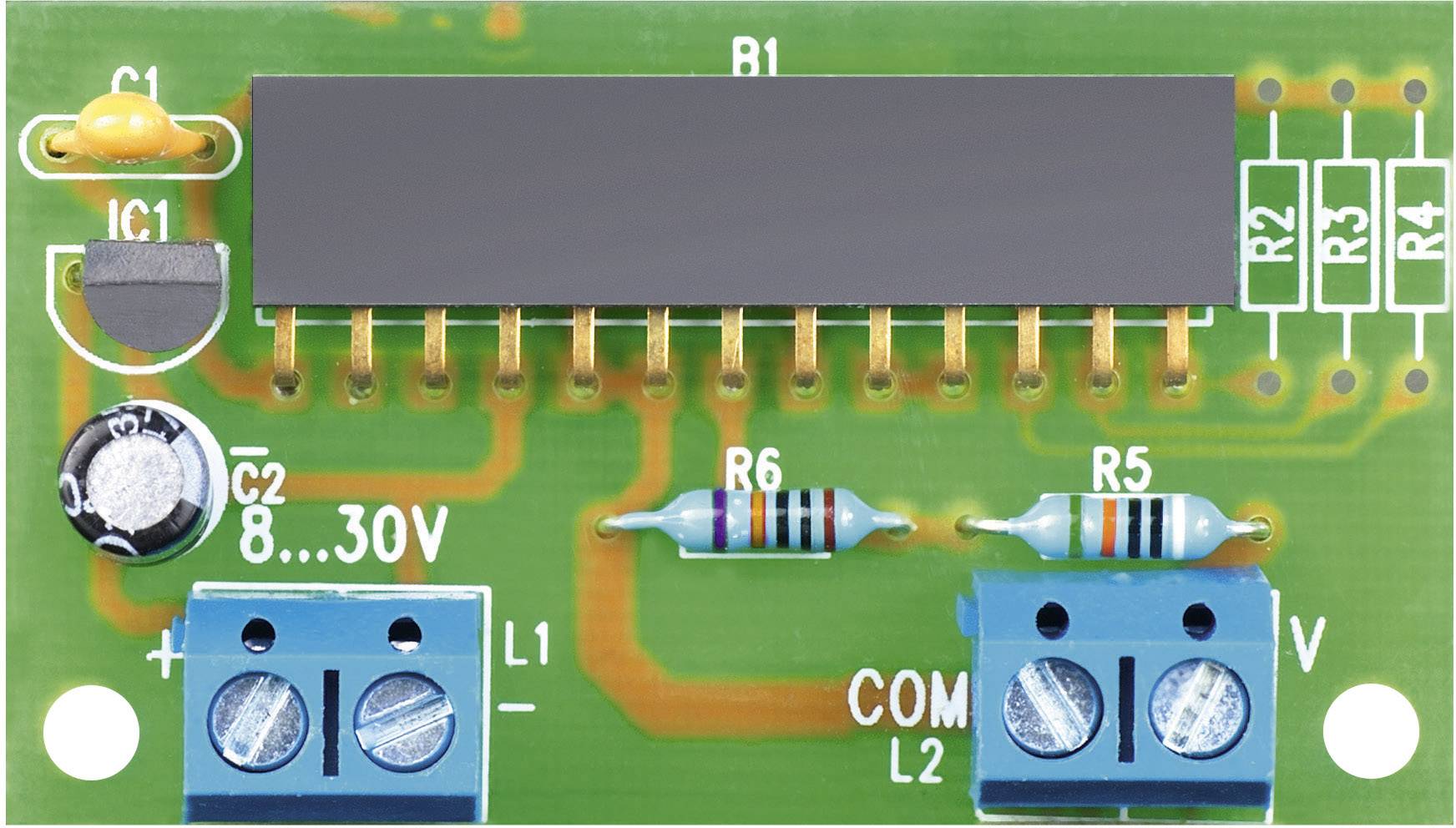 Green printed circuit board with electronic components such as resistors and a black integrated circuit chip, labelling shows voltage '8...30V'.