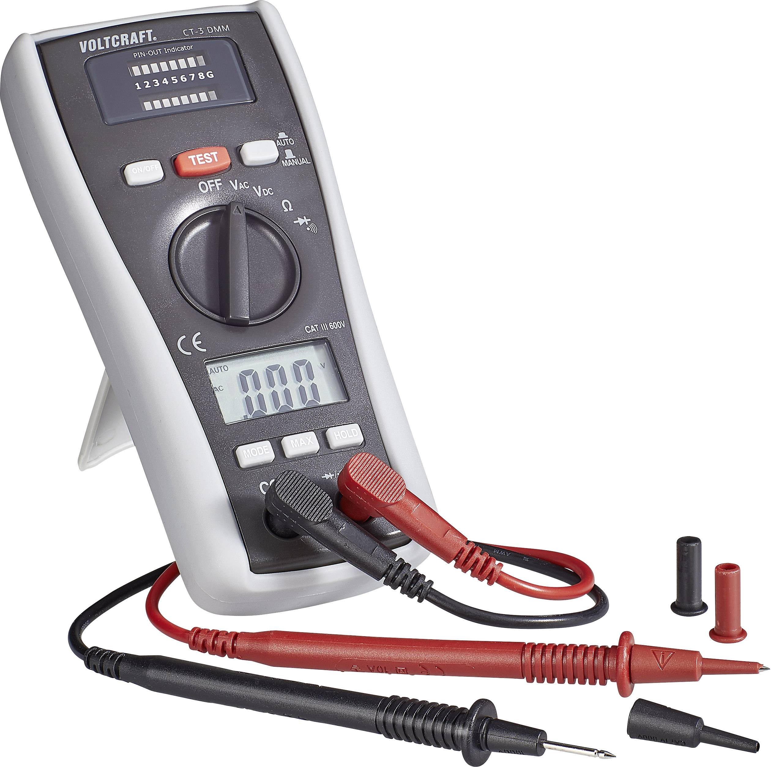 A digital multimeter displays 'AUTO' and '10.00' on the display. It has red and black test leads and is in measurement mode.