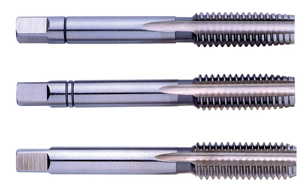 Three metal thread taps of varying sizes lie horizontally side by side. They are shiny and have fine, precise threads.