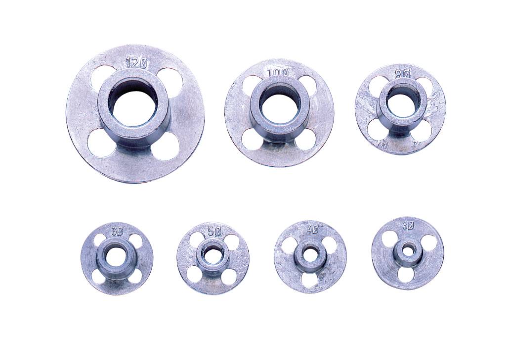Seven round metal parts with varying diameters. Each part has five holes and bears an embossed number.