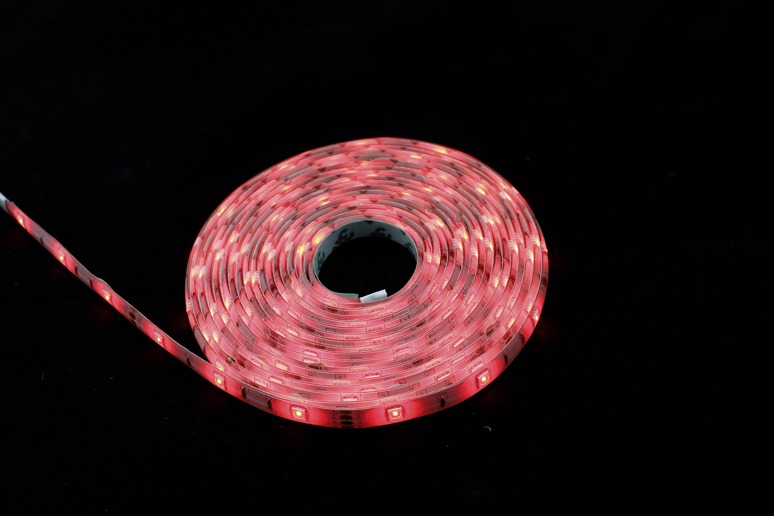 A coiled LED light string glows red against a dark background.