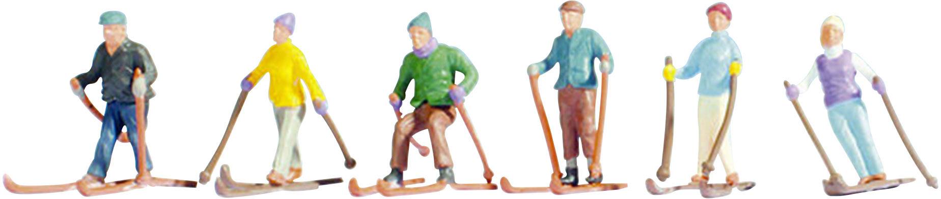 Six miniature figures on skis, each wearing different clothing, represent a group of skiers in various poses.