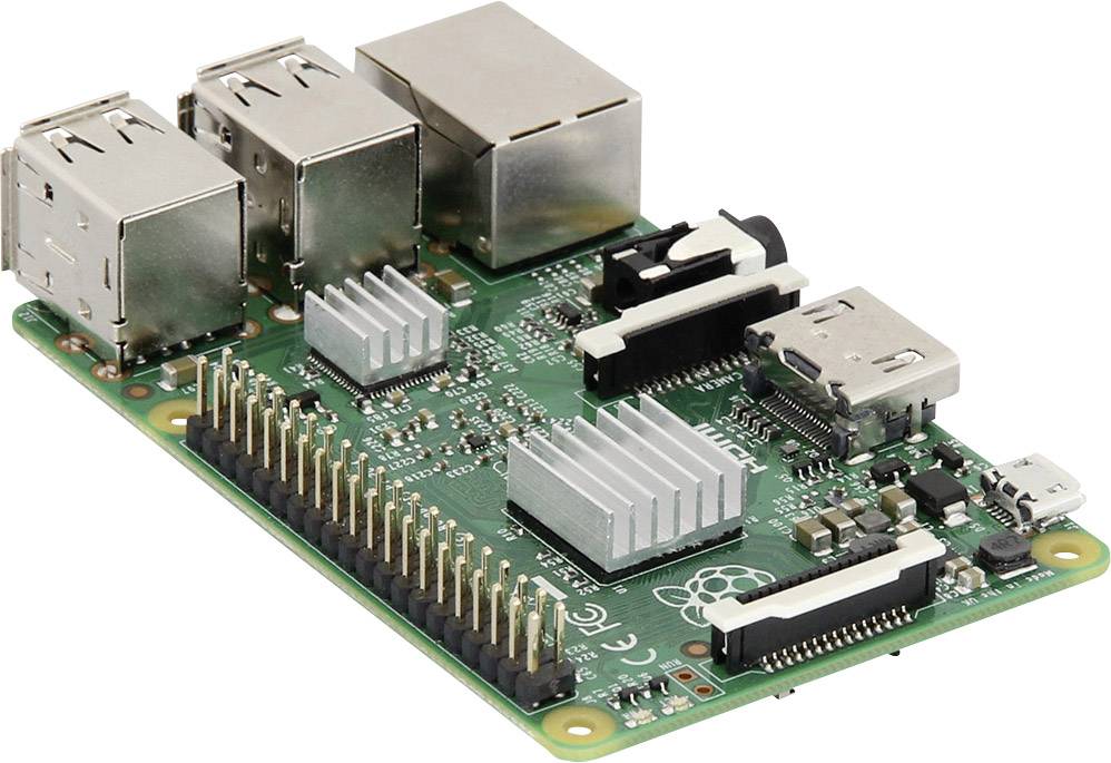 Small green circuit board with various electronic components, including connectors, chips, and slots, visible in the foreground.