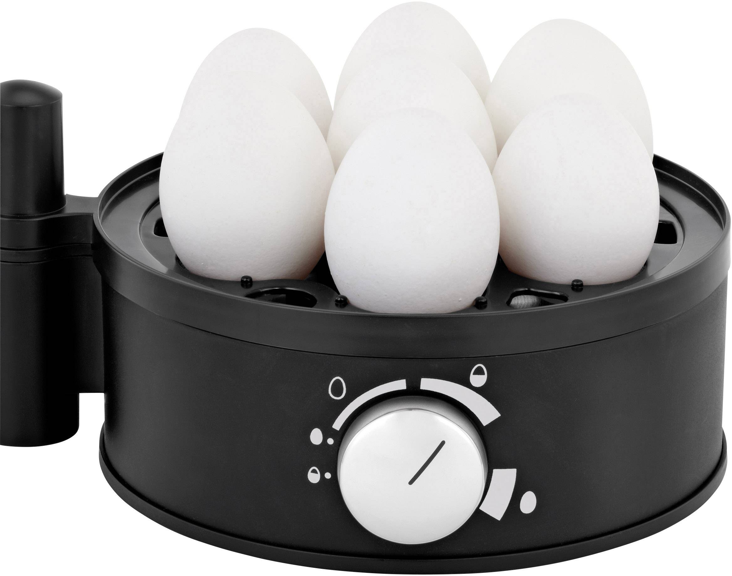 Six white eggs in a black egg cooker, with a rotary dial for adjusting cooking time visible at the front.