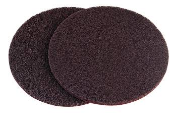 Two black cleaning pads made of coarse material, lying on top of each other, against a white background.
