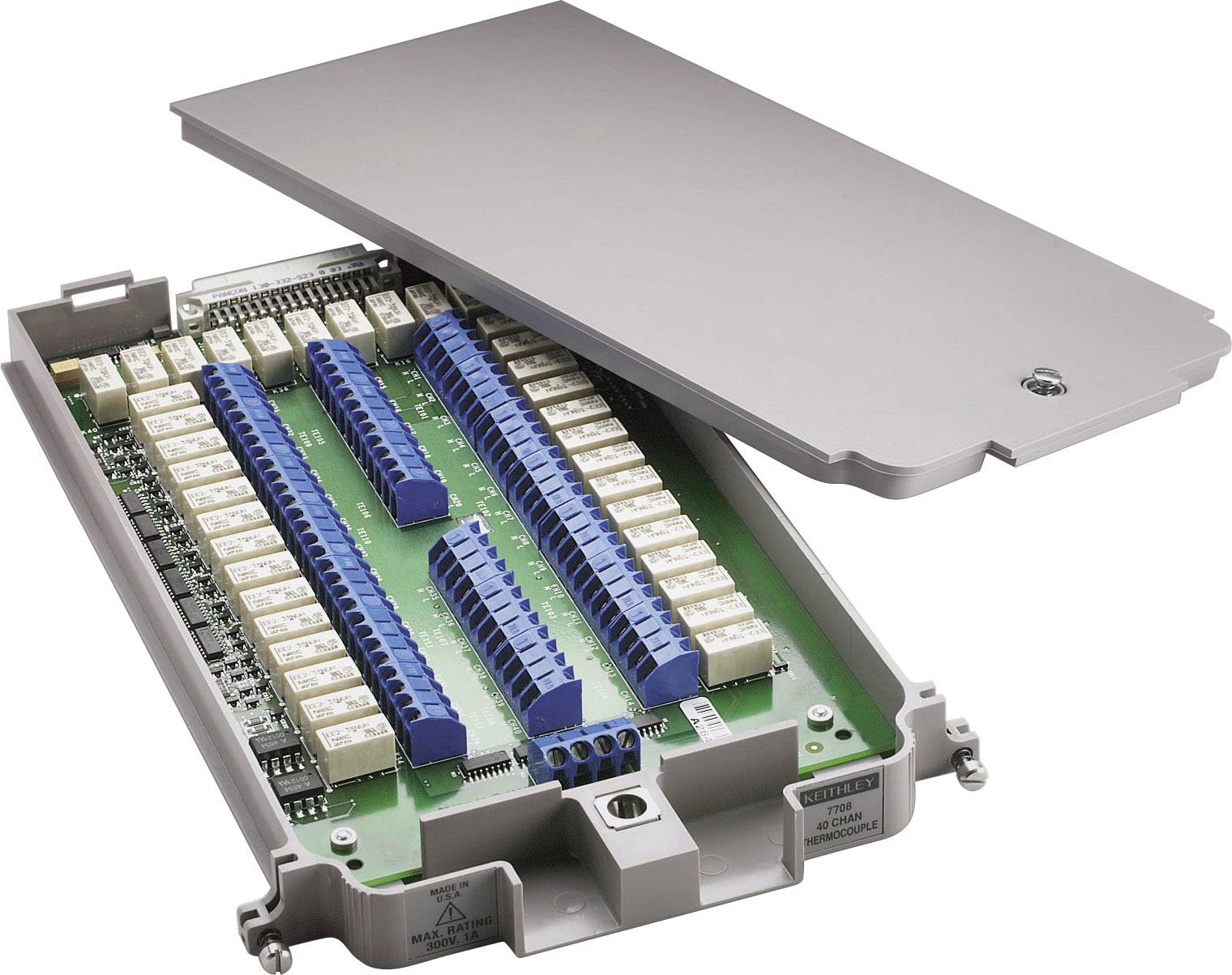 Electronic control unit with a removable cover, showing multiple rows of blue connectors and white components on a circuit board.
