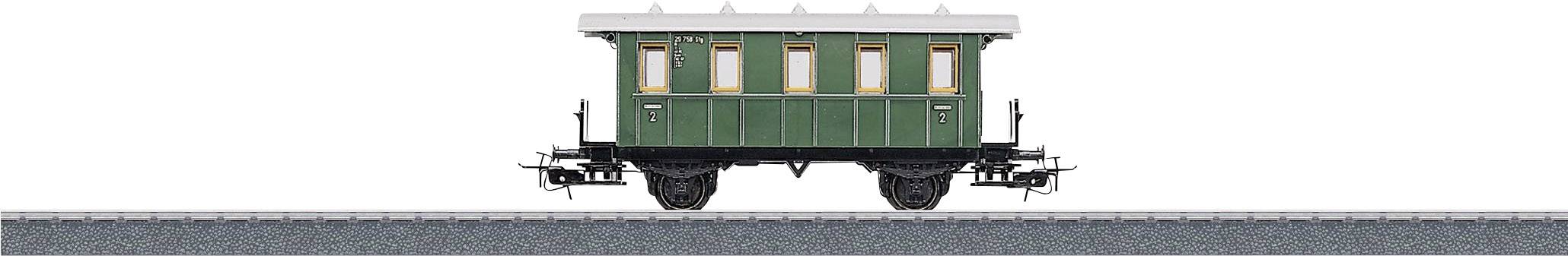 A green historical railway carriage with cream-coloured windows stands on a track.