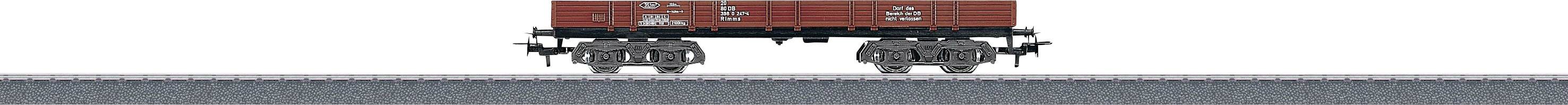 A red goods wagon on railway tracks, visible from the side profile. The background is neutral and devoid of discernible details.